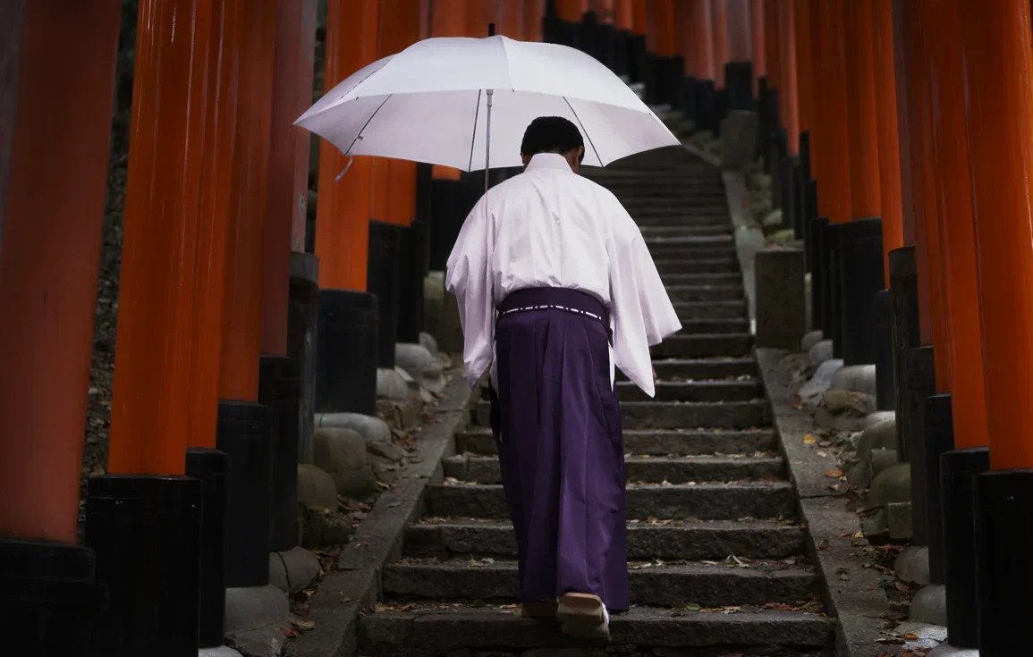 Shinto priest at Fushimi Inari Shrine, Kyoto, Japan.